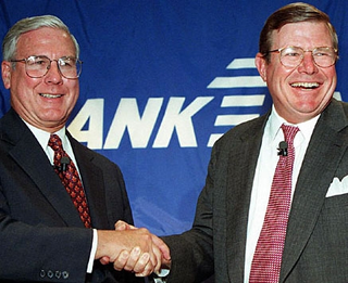 MCI-WorldCom CEO Donald Cosgrove (left) and Bank One-Chase Manhattan CEO Walter Courson celebrate their companies' historic $112 billion merger.